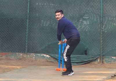 A team member batting at the practice nets during the firm's cricket day