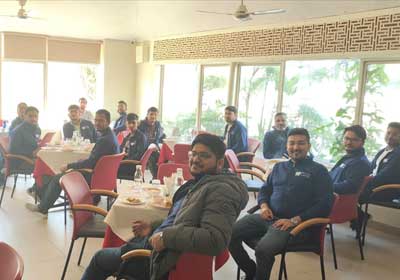 Team lunch at a restaurant, colleagues seated across several tables